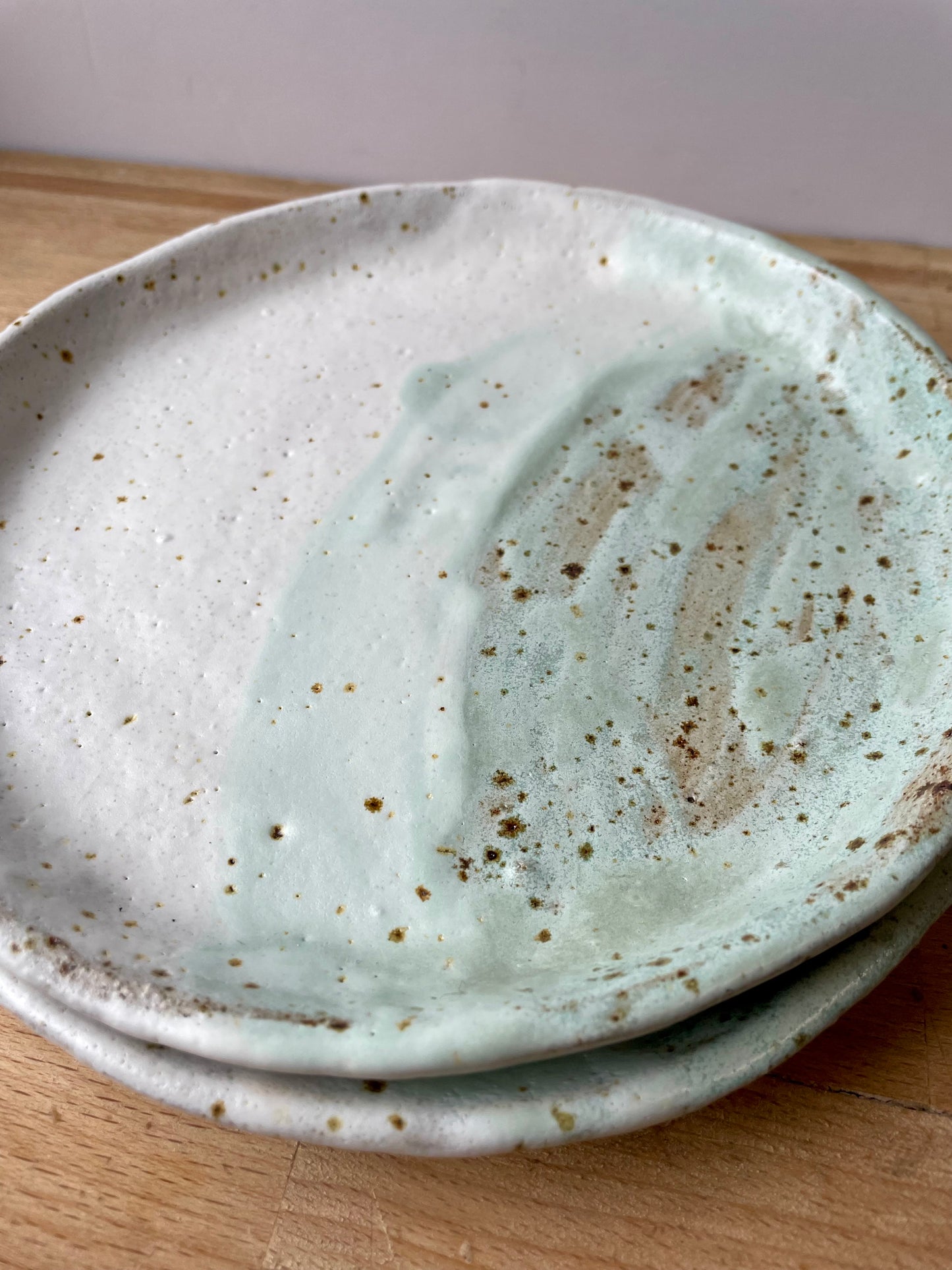 White and green speckled side plates