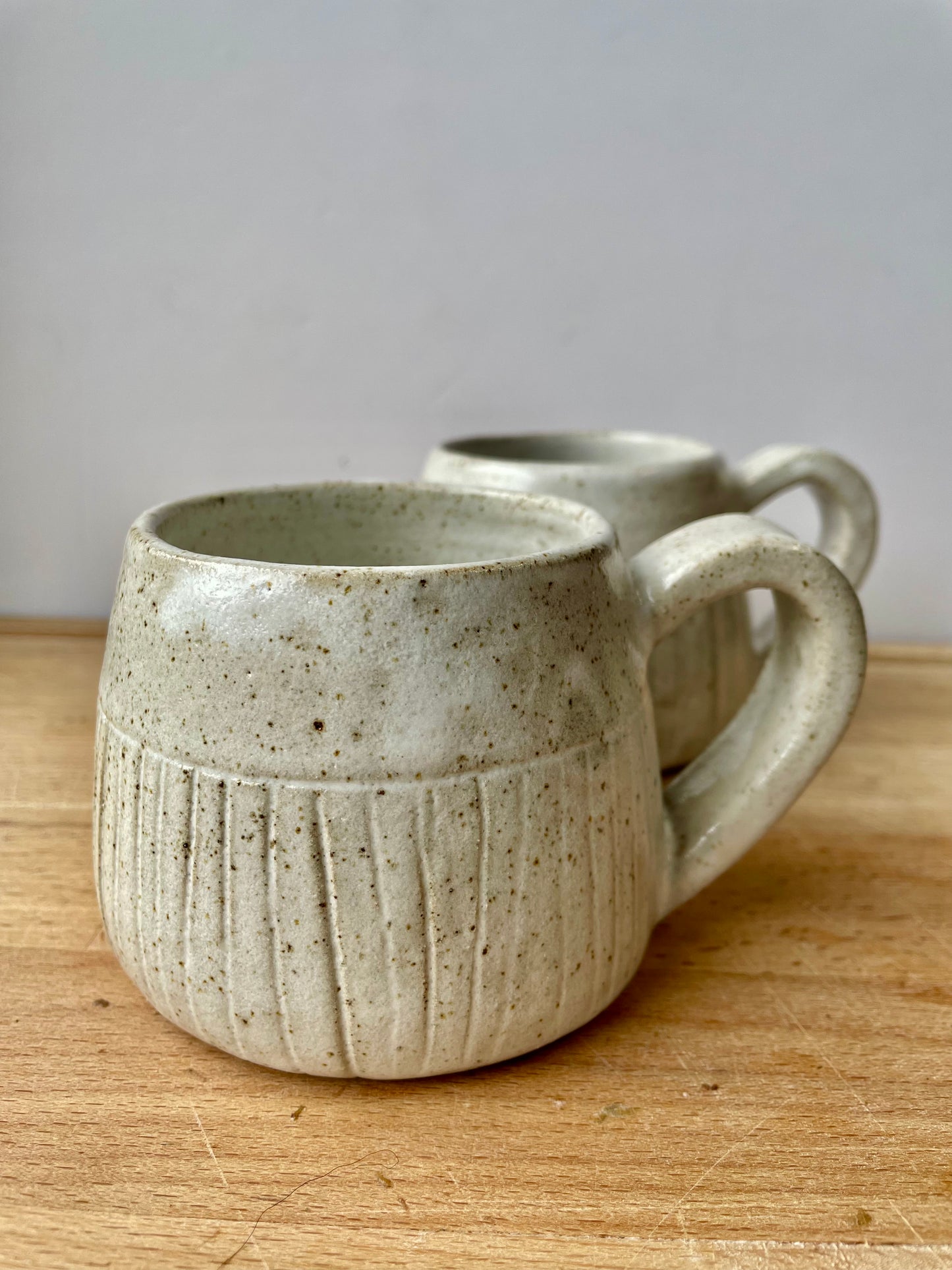 White speckled mugs with carved lines