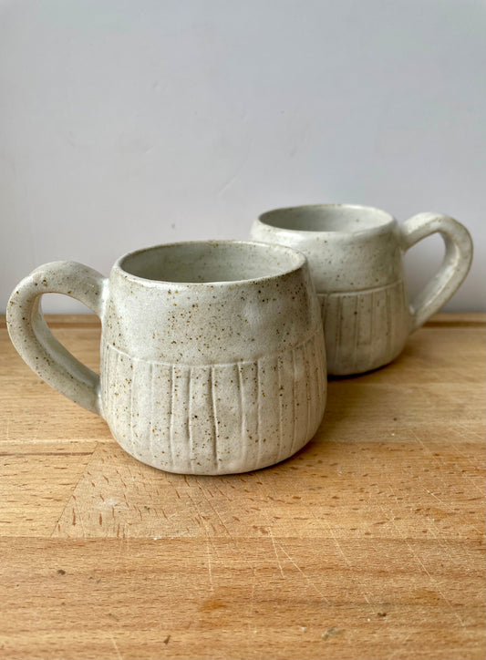 White speckled mugs with carved lines