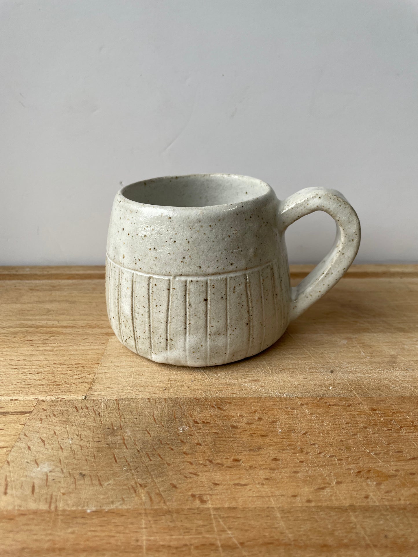 White speckled mugs with carved lines