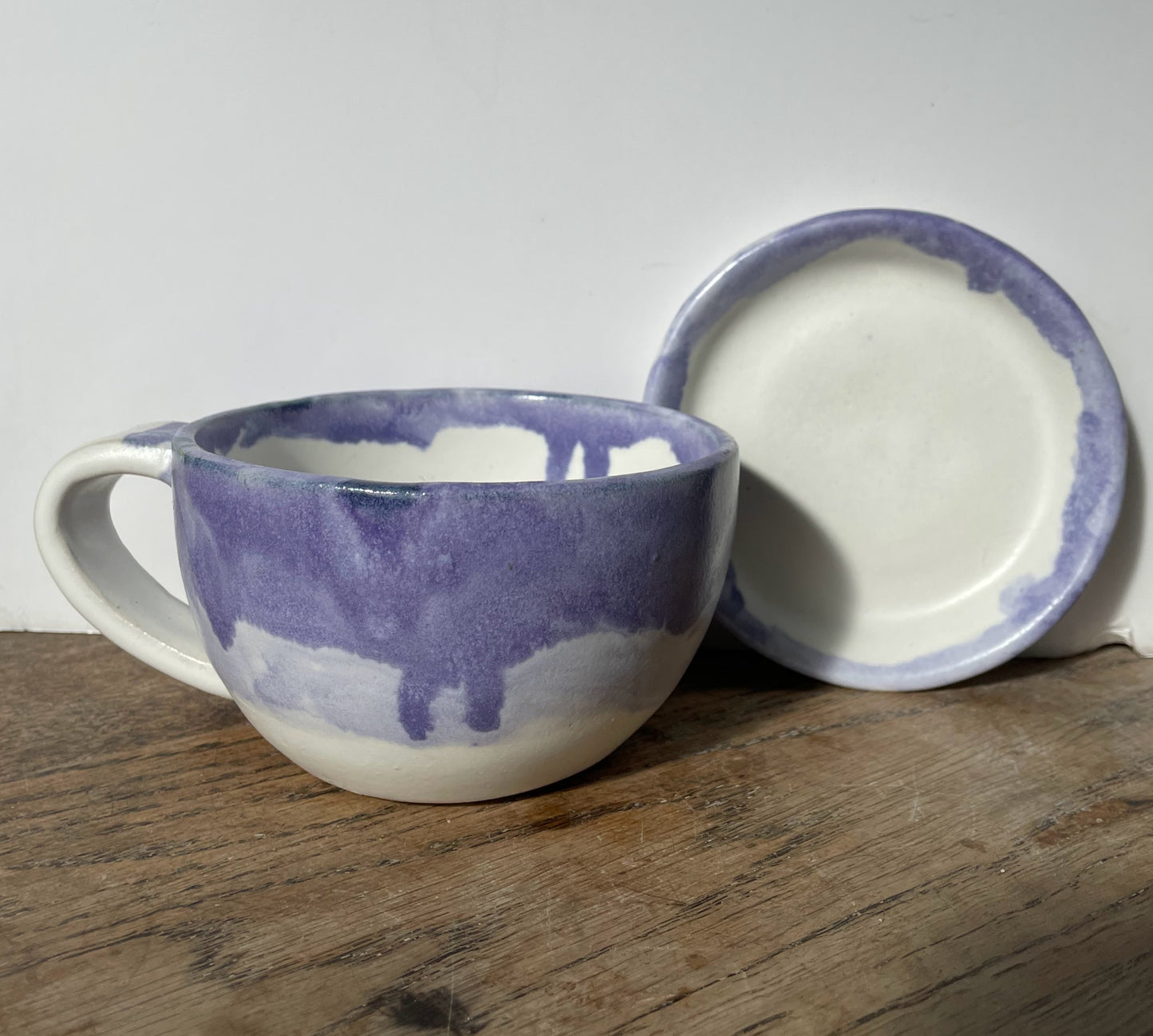 Cup and saucer with purple and white glaze