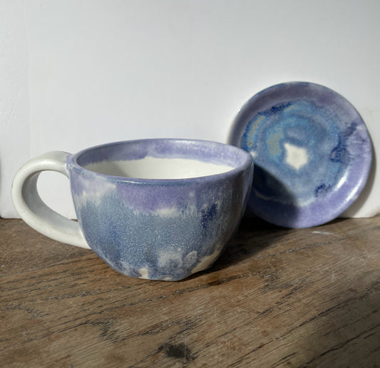 Cup and saucer with purple ,blue and white glaze