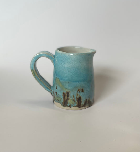 Blue jug with brown speckles